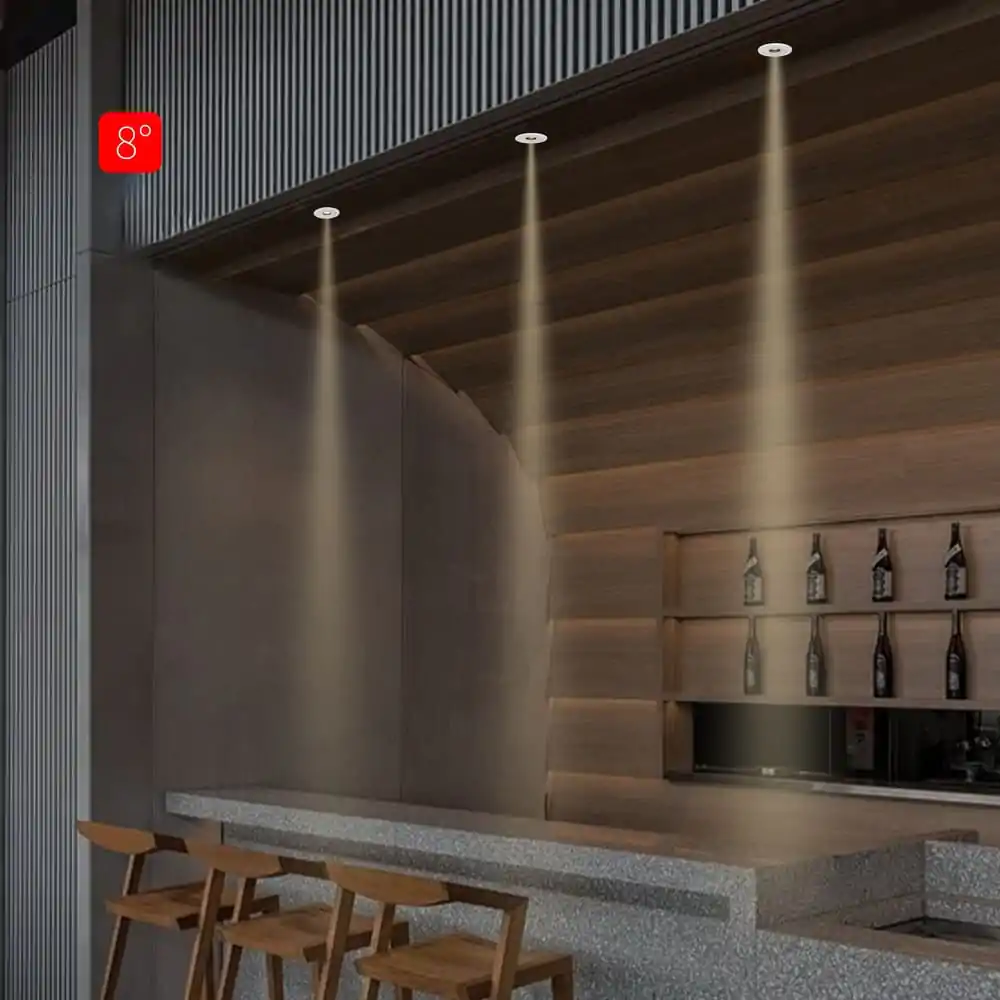 8Β° ceiling track lighting illuminating a modern bar area in a commercial space.