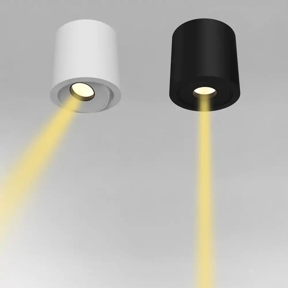 White and black recessed commercial spotlights emitting warm yellow light.